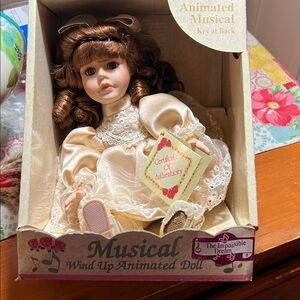 Musical Wind-Up Animated Doll in Cream Dress